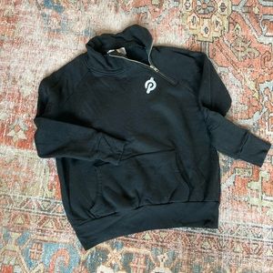 Peloton sweatshirt with side zip neckline and pocket.
